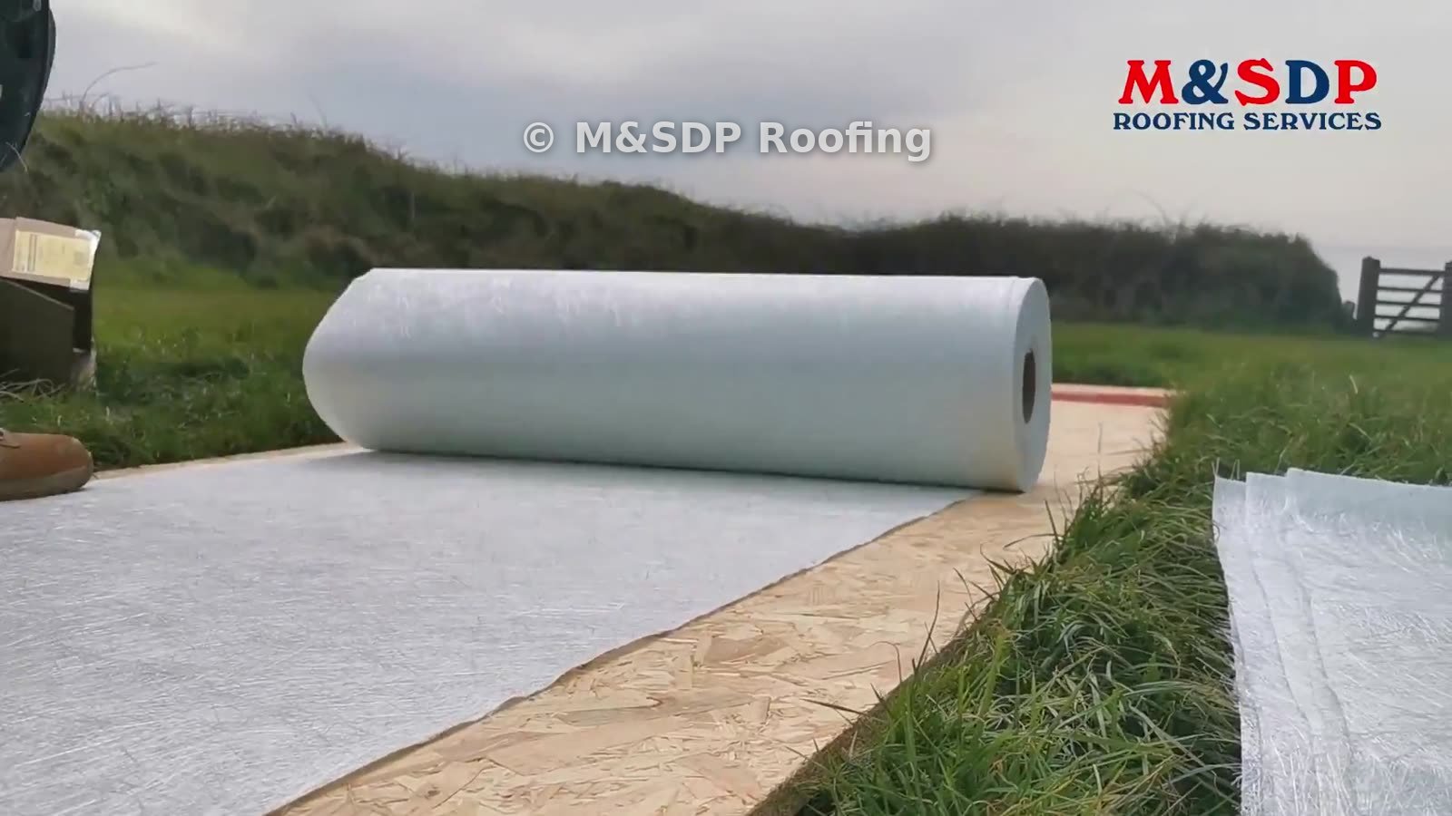 Roll of fibreglass matting on the flat roof deck