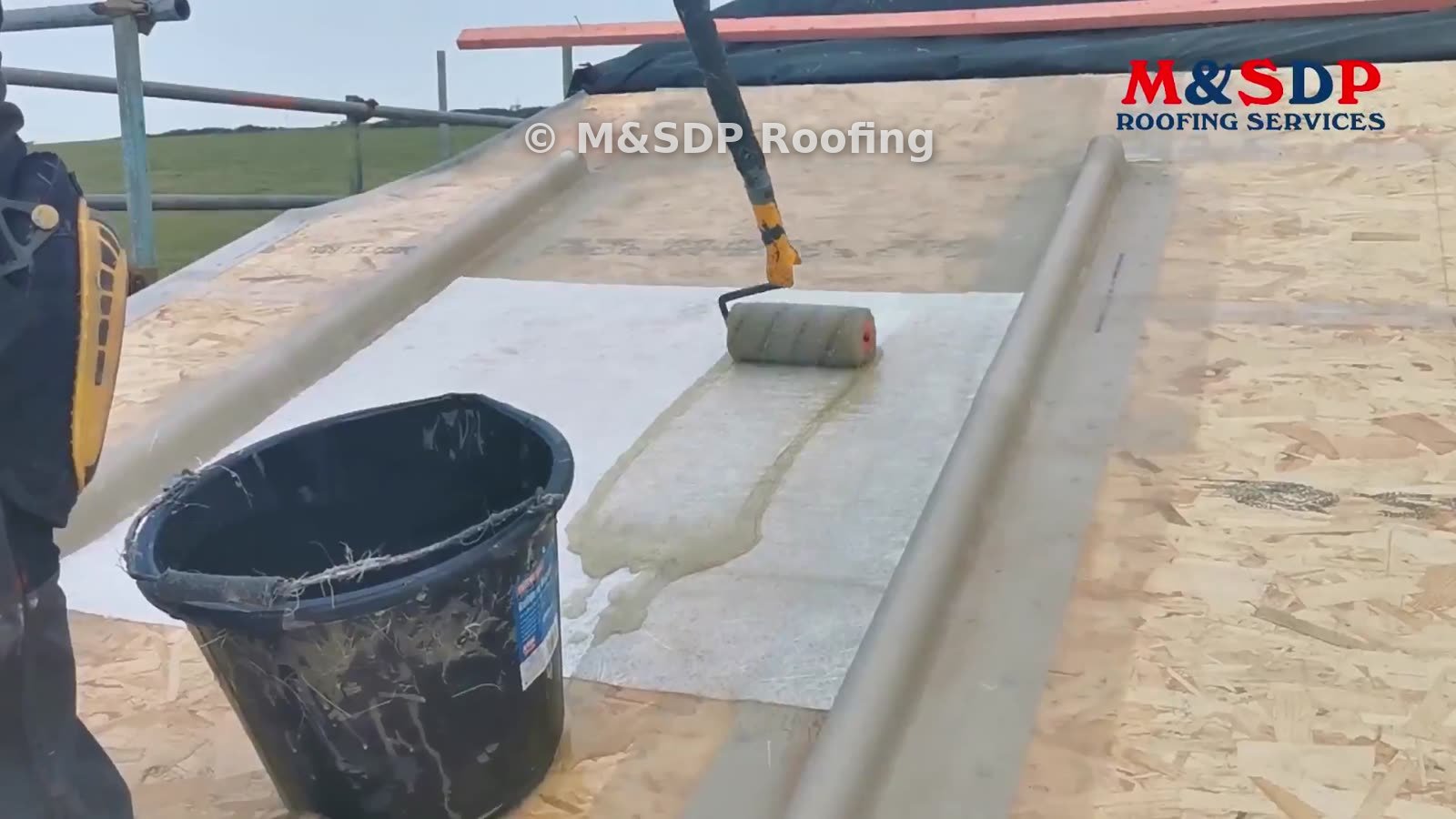 Resin being rolled into fibreglass matting