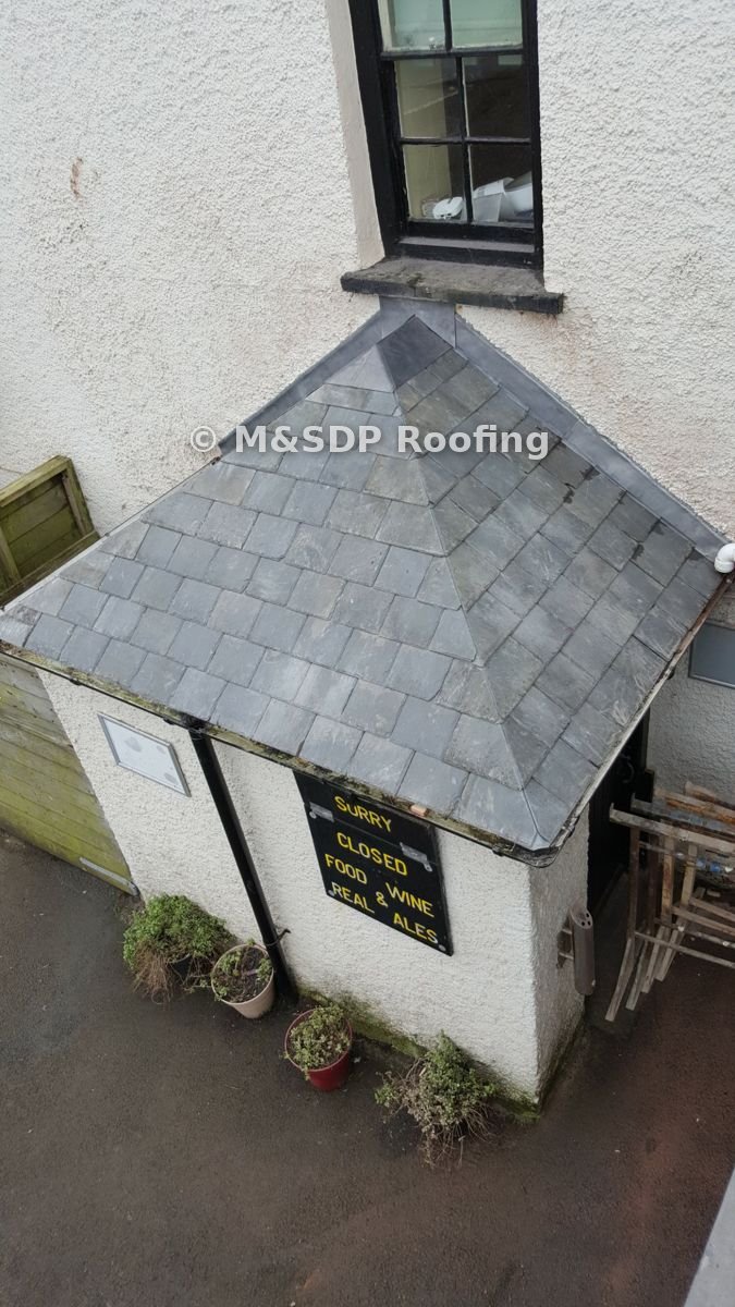 Porch roof in salvaged natural Welsh slate with mitred hips