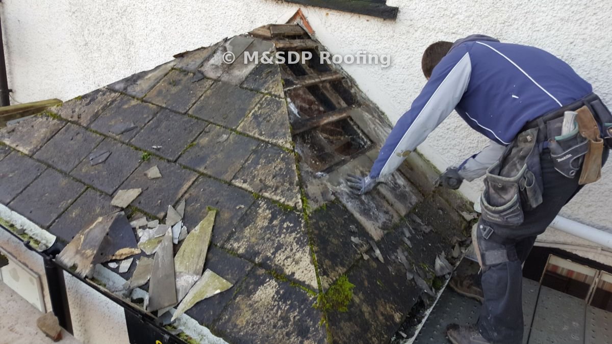 Stripping the old slates back to the rotten battens