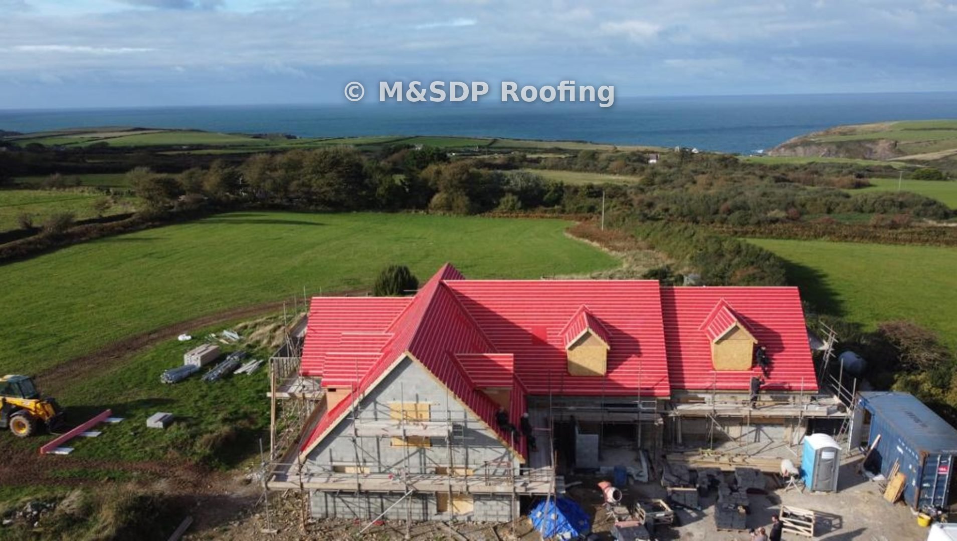 Roof in membrane and battens with dormers, sea in the distance